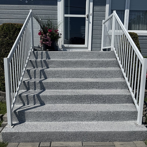 Escalier extérieur en époxy à granules gris avec bandes antidérapantes, réalisation VirezSulTop Époxy Design en Montérégie.